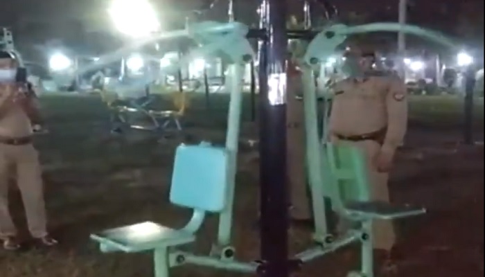 Cops in India stand in an outdoor gym. — Screengrab via Twitter/The Sun