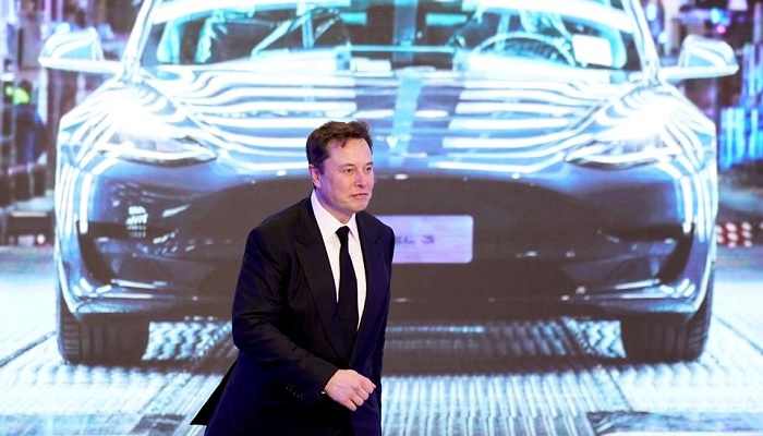 Tesla Inc CEO Elon Musk walks next to a screen showing an image of Tesla Model 3 car during an opening ceremony for Tesla China-made Model Y program in Shanghai, China January 7, 2020.—Reuters