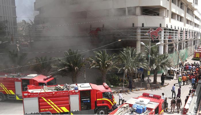 A view of smoke raises after a fire at a supermarket in Karachi, Pakistan, June 1, 2022. — INP