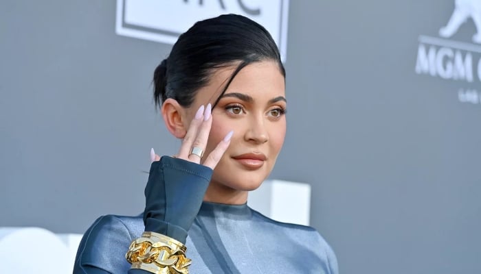 Kylie Jenner sets pulses racing in silver swimsuit just months after welcoming son