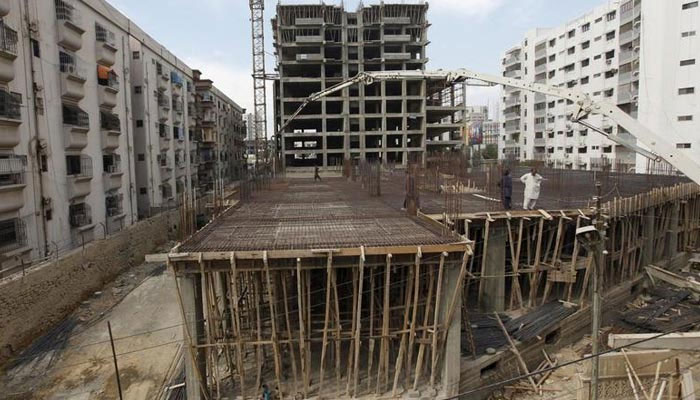 Labourers work on a building construction site in Karachi, Pakistan February 25, 2016. — Reuters/File