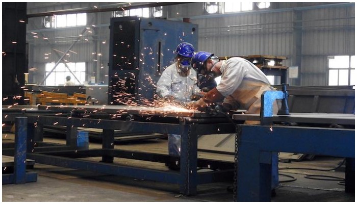 Two workers at a factory. — Reuters/File