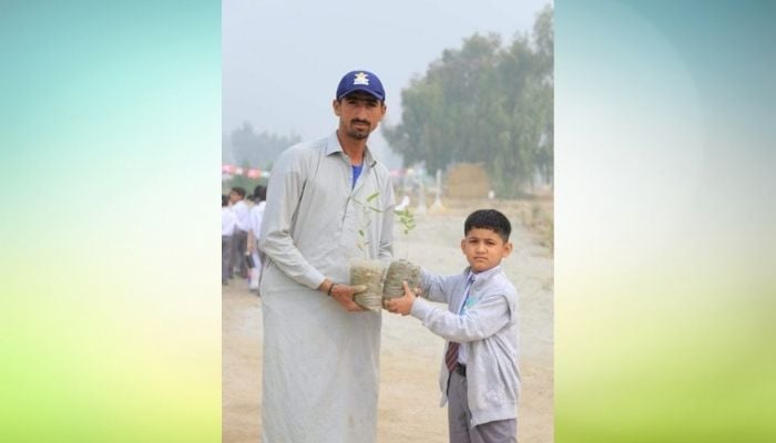 Pakistan cricket teams pacer Shahnawaz Dahani holding plant sapling with a student at an environment themed event in school.
