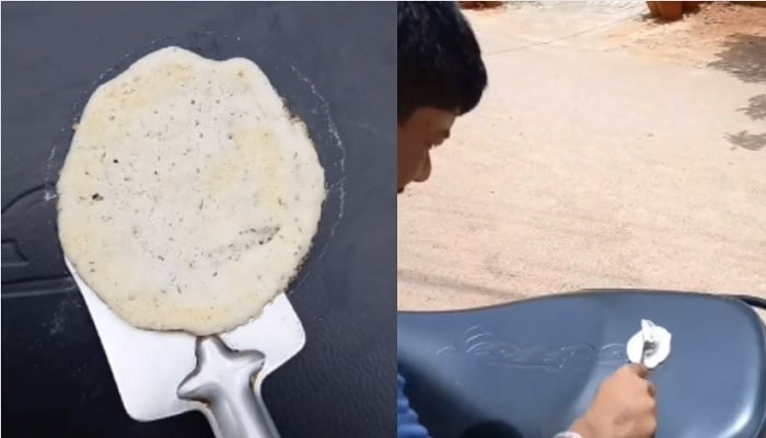 Seorang pria memasak di kursi skuter di India