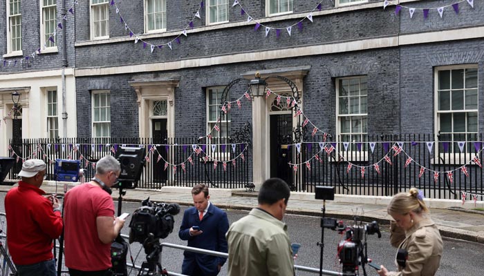 Members of the media work outside of 10 Downing Street, the official residence of Britains Prime Minister, in central London on June 6, 2022. — AFP/File
