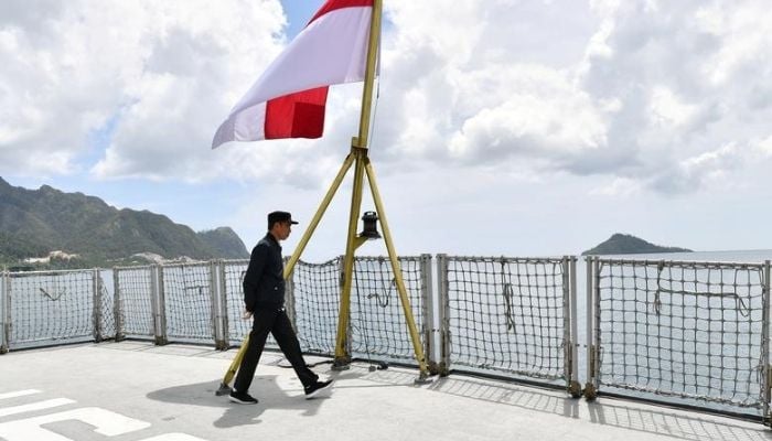 Indonesia President Joko Widodo walks past a national flag during his visit at a military base in Natuna, near South China Sea, Indonesia January 8, 2020.— Reuters