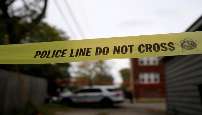 Yellow police tape is displayed at a crime scene after a motorist was shot in the head along the 2700 block of south 80th Street in Chicago, Illinois, U.S., November 1, 2017.—Reuters