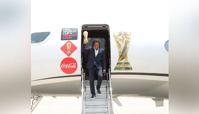 Christian Karembeu steps out of plane carrying solid-gold trophy weighing 6.1kg.— Twitter