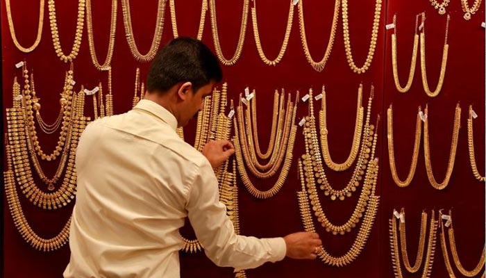 A salesman arranges gold ornaments, on a display board, inside a jewellery showroom during Akshaya Tritiya, a major gold-buying festival, in Kochi, India April 28, 2017. — Reuters/File