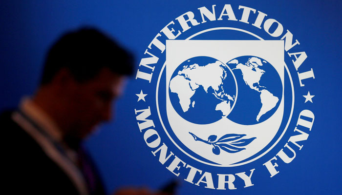 A participant stands near a logo of IMF at the International Monetary Fund - World Bank Annual Meeting 2018 in Nusa Dua, Bali, Indonesia, October 12, 2018. — Reuters