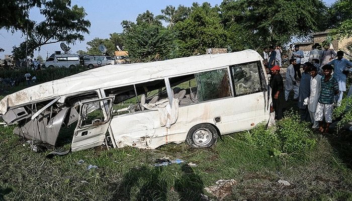 In this file photo, residents gather around the wreckage of a van alongside a railway track following the accident between a train and a van transporting Sikh pilgrims, in Punjab on July 3, 2020. — AFP