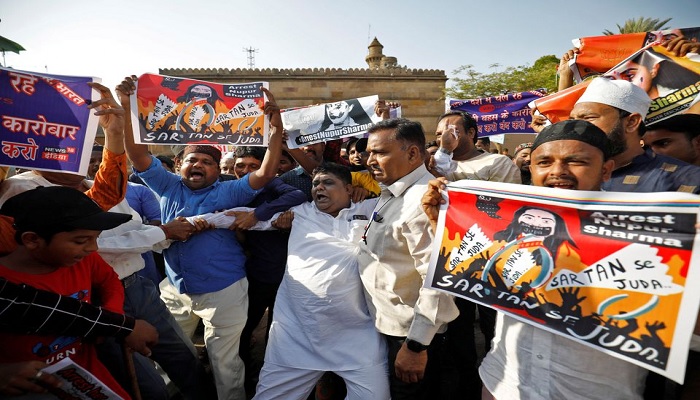 People shout slogans as they hold placards during a protest demanding the arrest of Bharatiya Janata Party (BJP) member Nupur Sharma for her comments on Prophet Mohammad (PBUH), in Ahmedabad, India, June 8, 2022.—Reuters