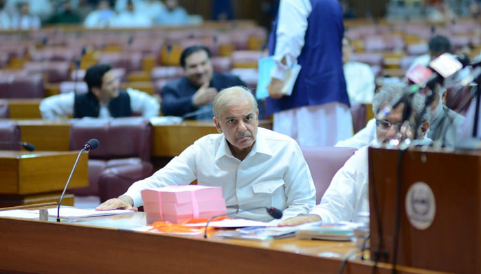 Prime Minister Shehbaz Sharif thumping the desk of National Assembly as Finance Minister Miftah Ismail presents the federal budget. — PM Office