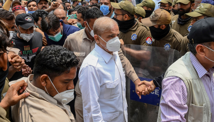 Shehbaz Sharif (C) arrives at the High Court in Lahore on July 16, 2020. — AFP/Arif Ali