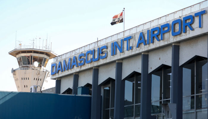 This file photo taken on October 1, 2020 shows the Syrian flag flying at Damascus International Airport outside Syrias capital. — AFP