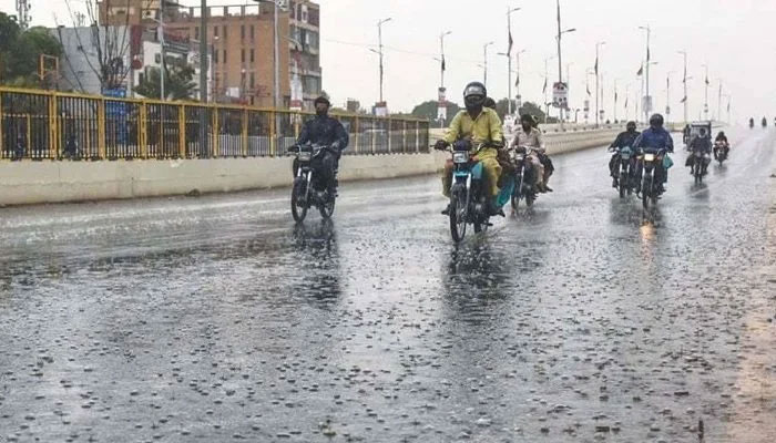 Motorcyclists can be seen on the roads of Karachi amid rain. Photo: File