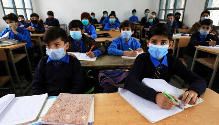 Students wear protective masks as they attend a class at school in Peshawar, Pakistan November 23, 2020. — Reuters