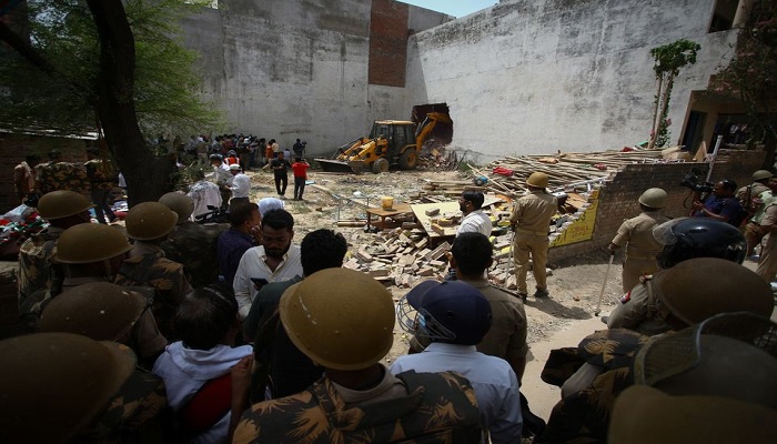 A bulldozer demolishes the house of a Muslim man that Uttar Pradesh state authorities accuse of being involved in riots last week, that erupted following comments about the Prophet Mohammed by Indias ruling Bharatiya Janata Party (BJP) members, in Prayagraj, India, June 12, 2022.— Reuters