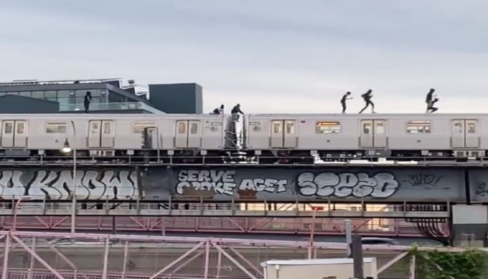 Some people are seen running and dancing on top of a moving train. — twitter/@GooseyMane
