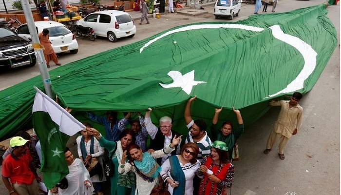 Supporters of civil rights group for transgender people, the Gender Interactive Alliance (GIA), dance and chant slogans as they pose with a national flag ahead of the Independence Day in Karachi, Pakistan, August 13, 2016.—Reuters