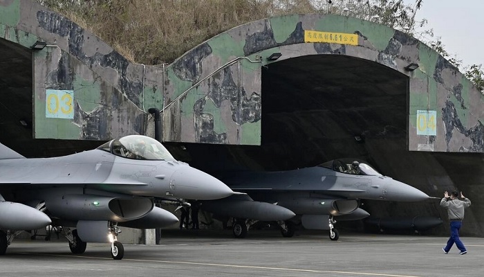 A Taiwanese Air Force staffer guides an US-made F-16V fighter at an air force base in Chiayi, southern Taiwan, on January 5, 2022.—AFP