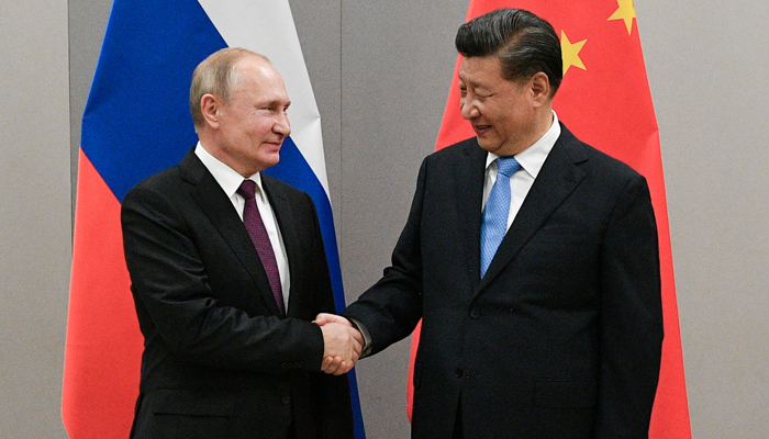 Russian President Vladimir Putin shakes hands with Chinese President Xi Jinping during their meeting on the sidelines of a BRICS summit, in Brasilia, Brazil, on November 13, 2019. — Reuters