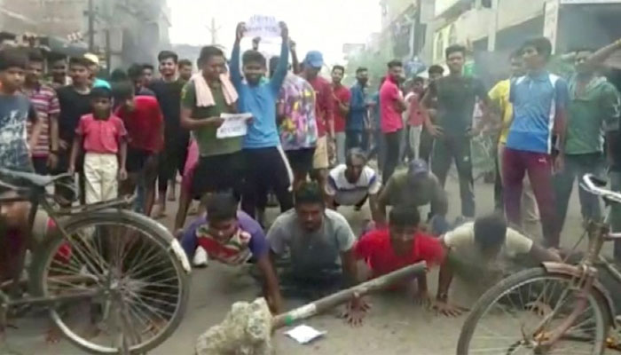 Demonstrators perform push-ups as they protest against Agnipath scheme for recruiting personnel for armed forces, in Munger, Bihar, India June 16, 2022 in this still image obtained from a handout video. — Reuters