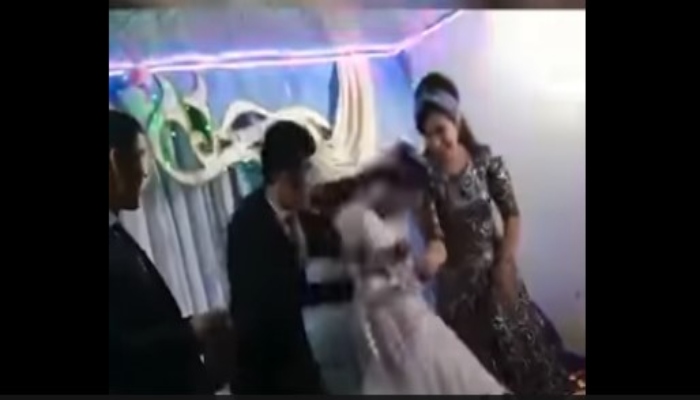 Man hitting his bride on the head during the wedding ceremony. — Screengrab via Twitter