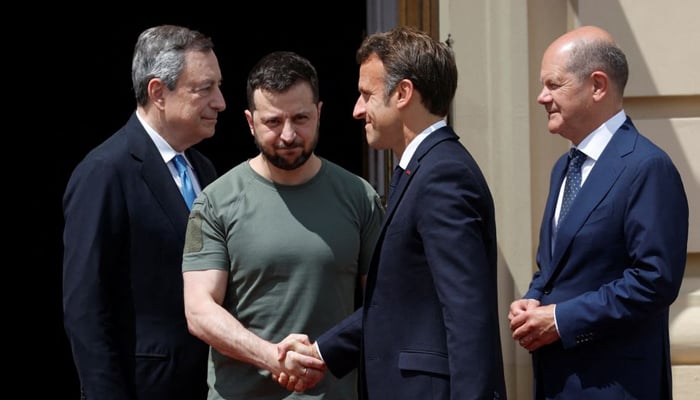 Ukrainian President Volodymyr Zelenskiy greets French President Emmanuel Macron as German Chancellor Olaf Scholz and Italian Prime Minister Mario Draghi stand outside the Mariyinsky Palace, as Russias attack on Ukraine continues, in Kyiv, Ukraine June 16, 2022. — Reuters