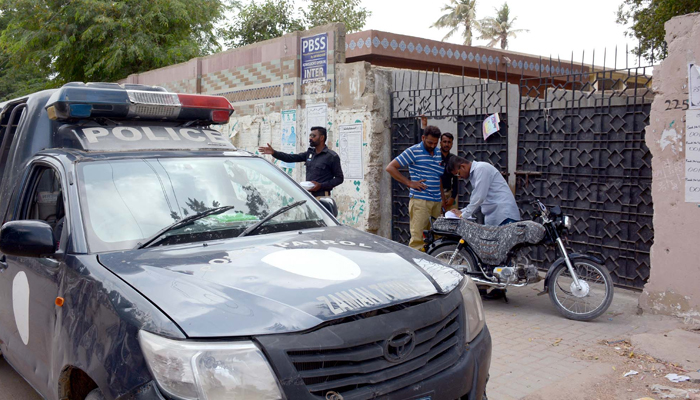 Security officials are checking voters at a polling station during the by-elections in NA-240 constituency held Karachis Korangi area on Thursday, June 16, 2022. — S.Imran Ali/PPI Images