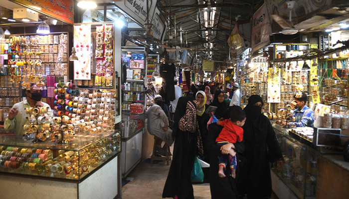 People shop in a market in Karachi, on May 11, 2020. — AFP