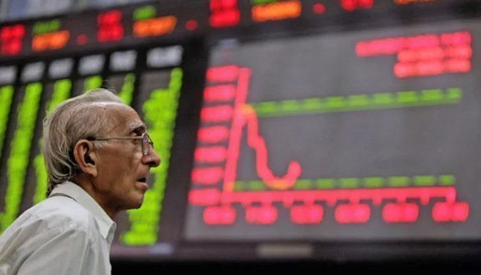 A investor looks at the days trading at the KSE-100 Index. — AFP/File