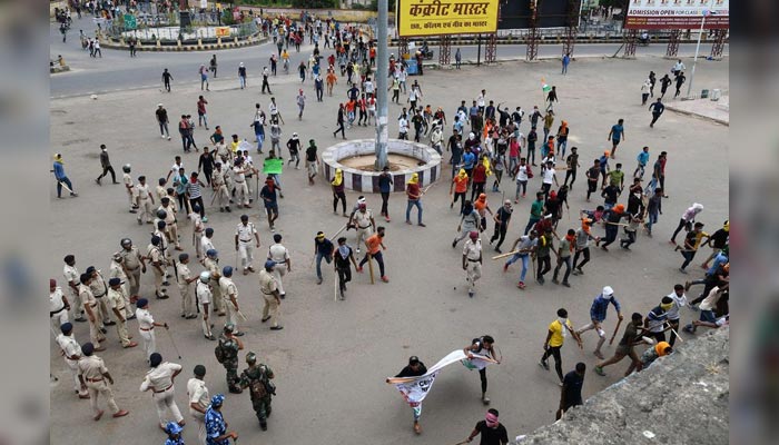 Protestors carry sticks as they enter a railway station during a protest against Agnipath scheme for recruiting personnel for armed forces, in Patna, in the eastern state of Bihar, India, June 17, 2022. — Reuters/File