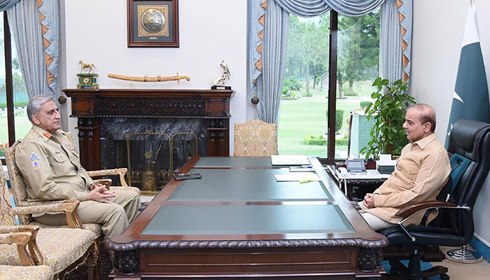 This handout photograph taken on April 19, 2022, and released by the Pakistan Prime Ministers Office shows Prime Minister Shehbaz Sharif (right) speaking with Army Chief General Qamar Javed Bajwa at the Prime Minister House in Islamabad. — AFP