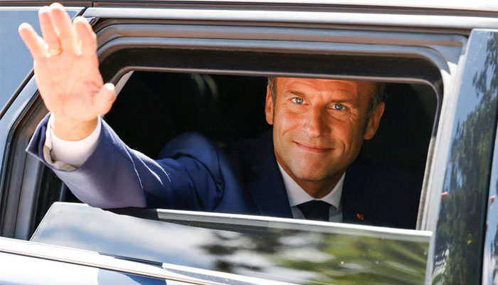 French President Emmanuel Macron waves as he votes in the first round of French parliamentary elections, at a polling station in Le Touquet, France, June 12, 2022. — Reuters