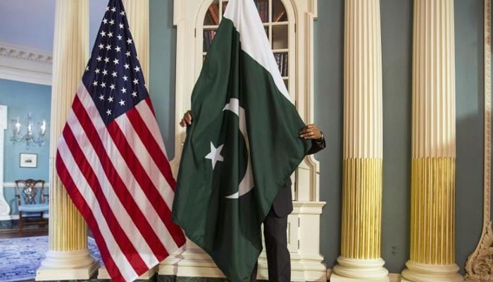 A State Department contractor adjust a Pakistan national flag before a meeting on the sidelines of the White House Summit on Countering Violent Extremism at the State Department in Washington. — Reuters/File