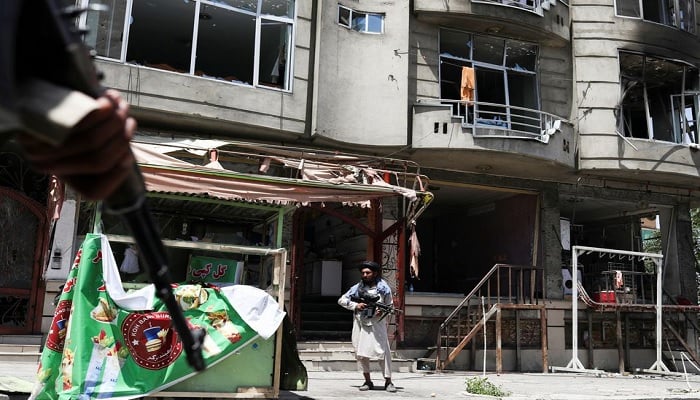 A Taliban fighter stands guard at the site where an explosives-laden vehicle detonated amidst an attack on a Sikh Temple in Kabul, Afghanistan, June 18, 2022.—Reuters