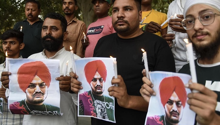 People hold a vigil last month in the Indian city of Amritsar for murdered Punjabi rapper Sidhu Moose Wala.—AFP