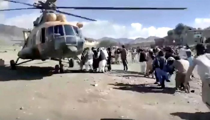 People carry injured to a helicopter following a massive earthquake, in Paktika Province, Afghanistan, June 22, 2022, in this screen grab taken from a video.—Reuters