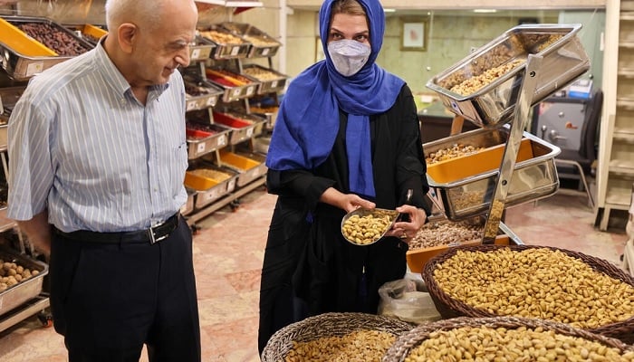 Iranian pistachio wholesaler Abbas Emami and his daughter Marjan.—AFP