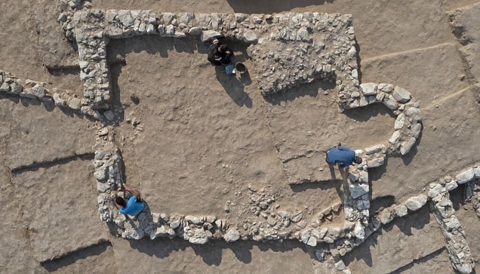 An aerial view shows Palestinian workers of Israels Antiquities Authority at the recently discovered ancient mosque.—AFP