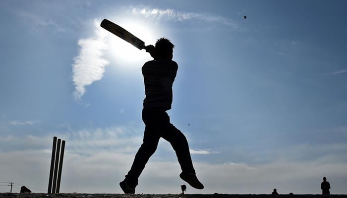 The picture shows a silhouette of a person playing cricket. — AFP/File