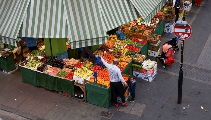 A man shops for fruit and vegetables at Brixton Market, amid the spread of the coronavirus disease (COVID-19) in London, Britain, September 27, 2020.—Reuters