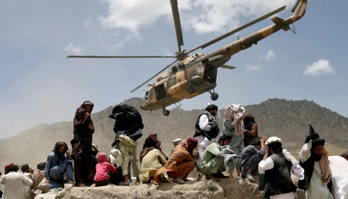A Taliban helicopter departs after delivering aid to the earthquake site in Gayan, Afghanistan — Reuters