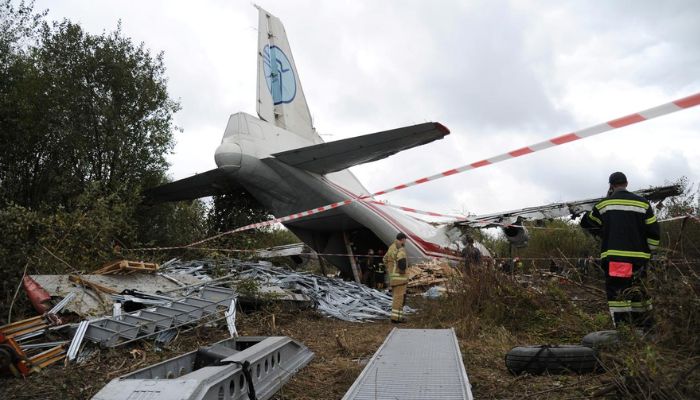 Members of emergency services work at the site of the Antonov-12 cargo airplane emergency landing in Lviv region, Ukraine October 4, 2019. —Reuters