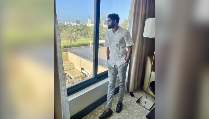 Babar Azam looks out the window and poses in this undated photo. — Twitter/babarazam258