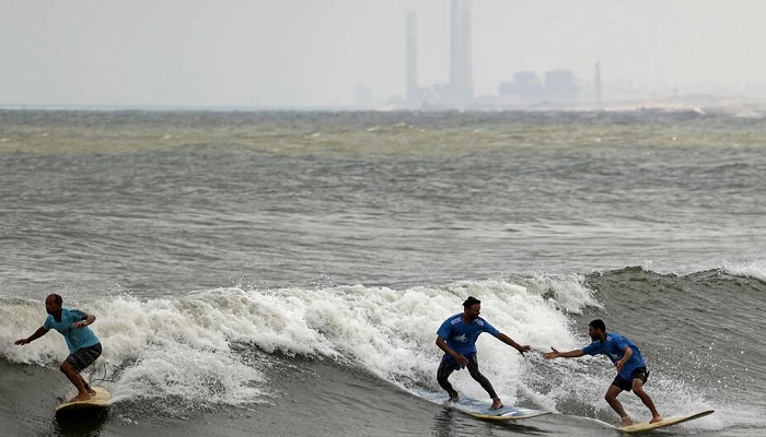 Palestinian surfers ride a wave off Gaza City Mahmud.—AFP