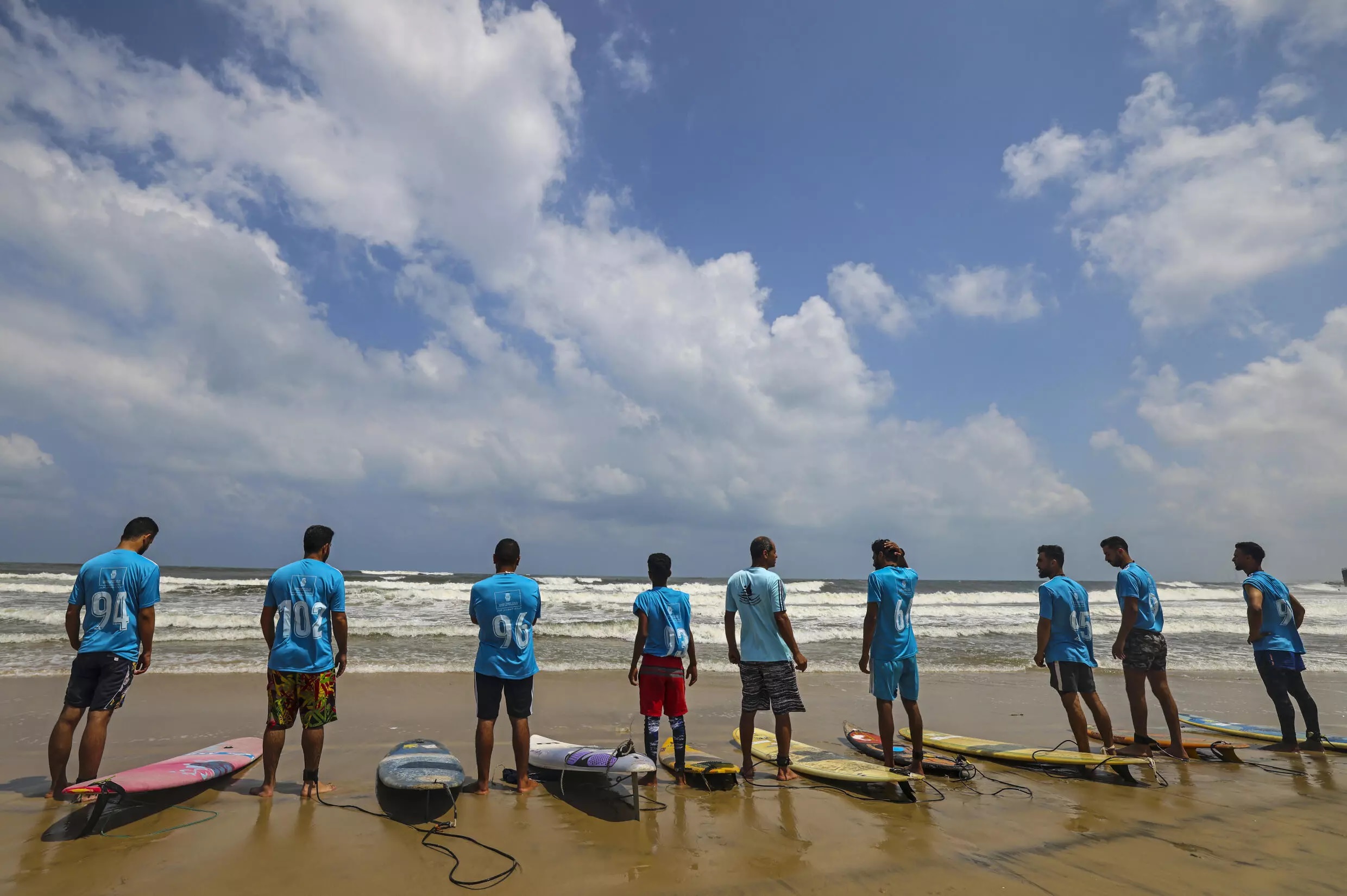 Palestinian surfers prepare to ride waves.—AFP