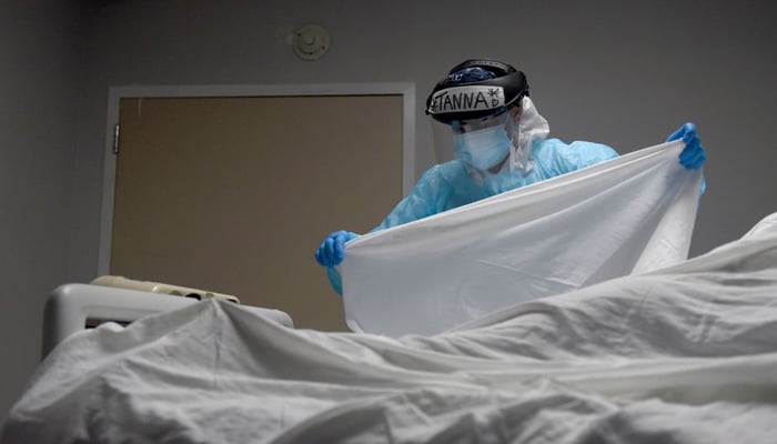 Tanna Ingraham places a sheet over the body of a patient who died inside the coronavirus disease (COVID-19) unit at United Memorial Medical Center in Houston, Texas, US, December 30, 2020. — Reuters