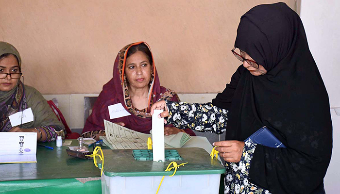 A woman casting her vote at a polling station for a by-election in NA 240 in Karachi, on June 16. — APP